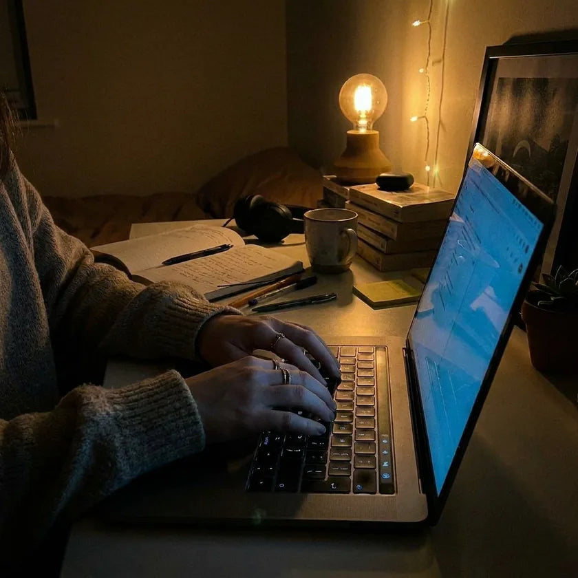Person working on a laptop at a desk