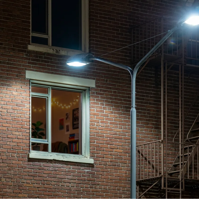 Street lamp illuminating a brick building at night